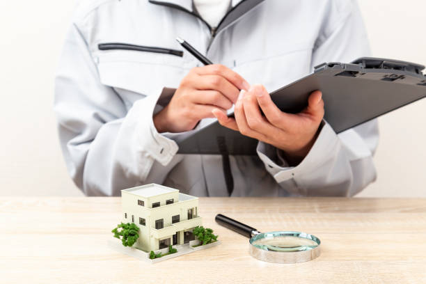 a house model and a woman wearing work clothes